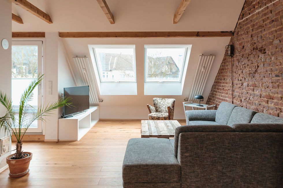 Modern loft living room with gray sofa, rustic wood coffee table