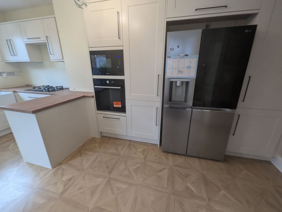 Kitchen area with white cabinets
