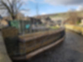 canal side scaffolding providing access to stone retaining wall