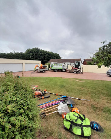 Hedge trimming taking place in garden of home