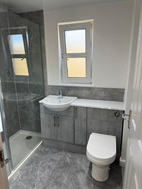 grey slate style cabinets in bathroom with modern shower and toilet