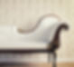 Interior photo featuring a vintage sofa set against a backdrop of patterned, retro-style wallpaper.
