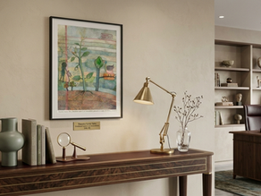 A collector examining an artwork in a gallery while considering its price, value, artist background and market context.
