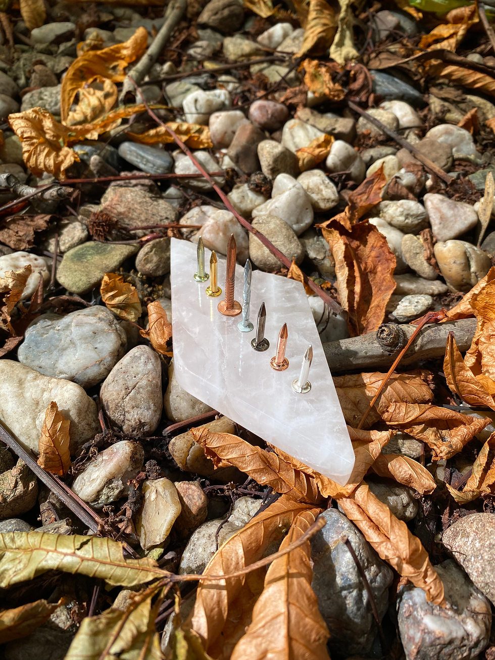 Thumbnail: Crystal pendant with embedded zinc and copper nails, surrounded by natural stones and dried leaves; a unique piece symbolizin