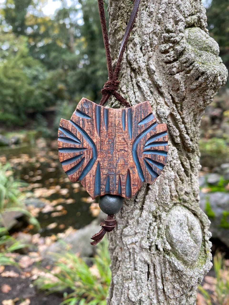 Thumbnail: Sustainable cedar owl pendant on tree bark, nature-inspired organic jewelry for mindful living.