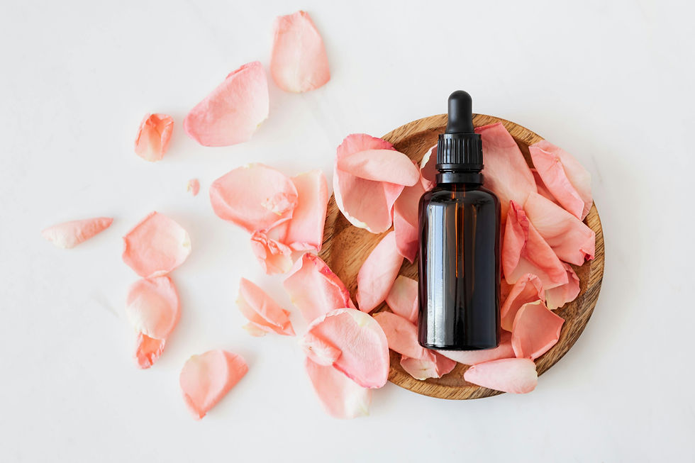 An essential oil bottle with flower petals