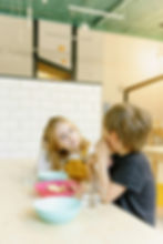 a boy and girl having after school snacks