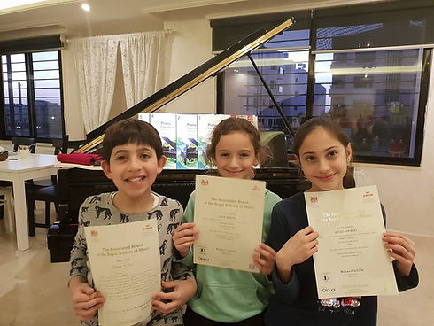 Piano students holding certificates