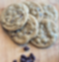 Chocolate chip cookies with sea salt on a wood board