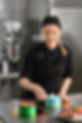 beautiful-cute-girl-smiling-decorating-cake-young-confectioner-wearing-black-uniform-while