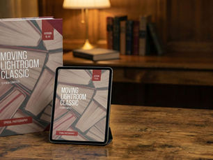 Book detailing how to move Lightroom to new computer on wooden table, soft lamp glow, books in background. Warm, cozy setting.
