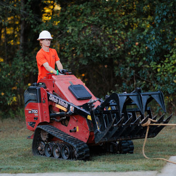 Anchoring a tree using a skid steer so they can cut and drop it