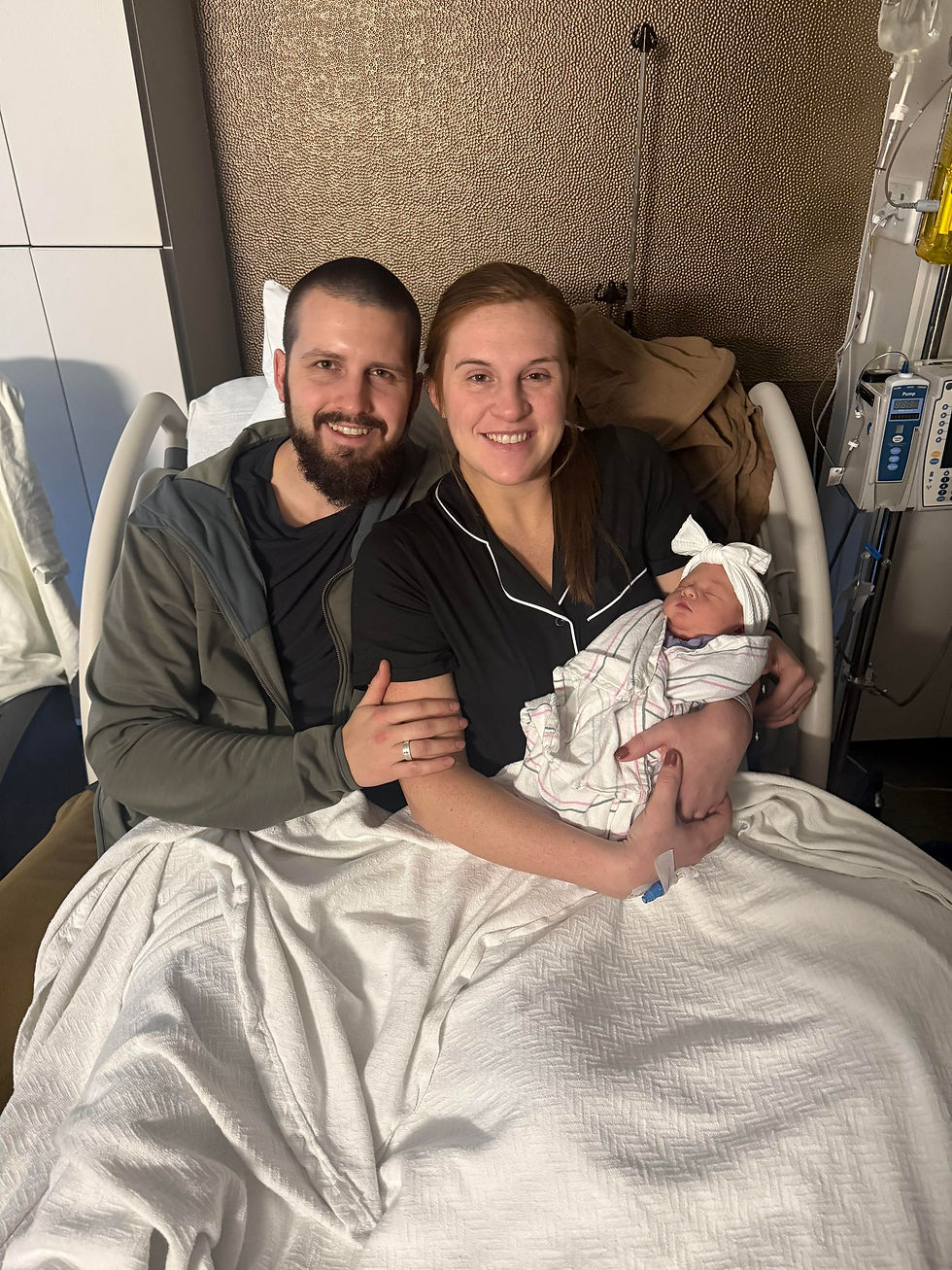 Parents with baby in hospital bed