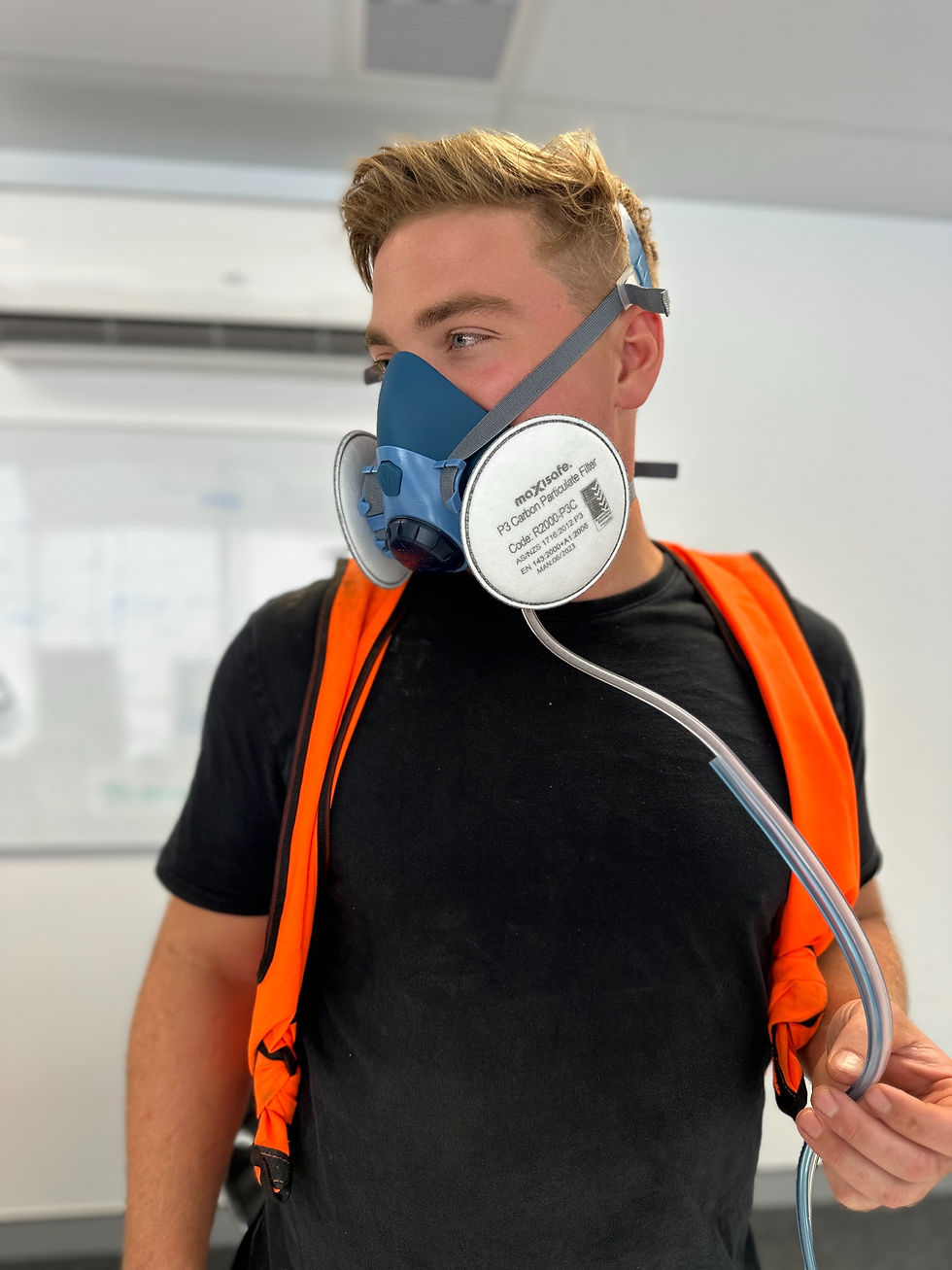 Worker in high-vis wearing a half-face respirator