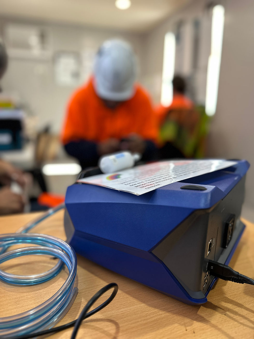 Worker undergoing a quantitative fit test (QNFT) using a fit test machine to determine fit factor