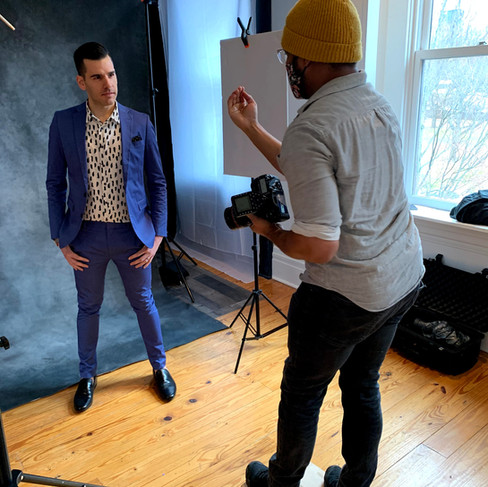 Photographer photographing standing client in blue suit