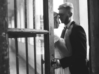 Black and white wedding photograph of bride and groom holding each other