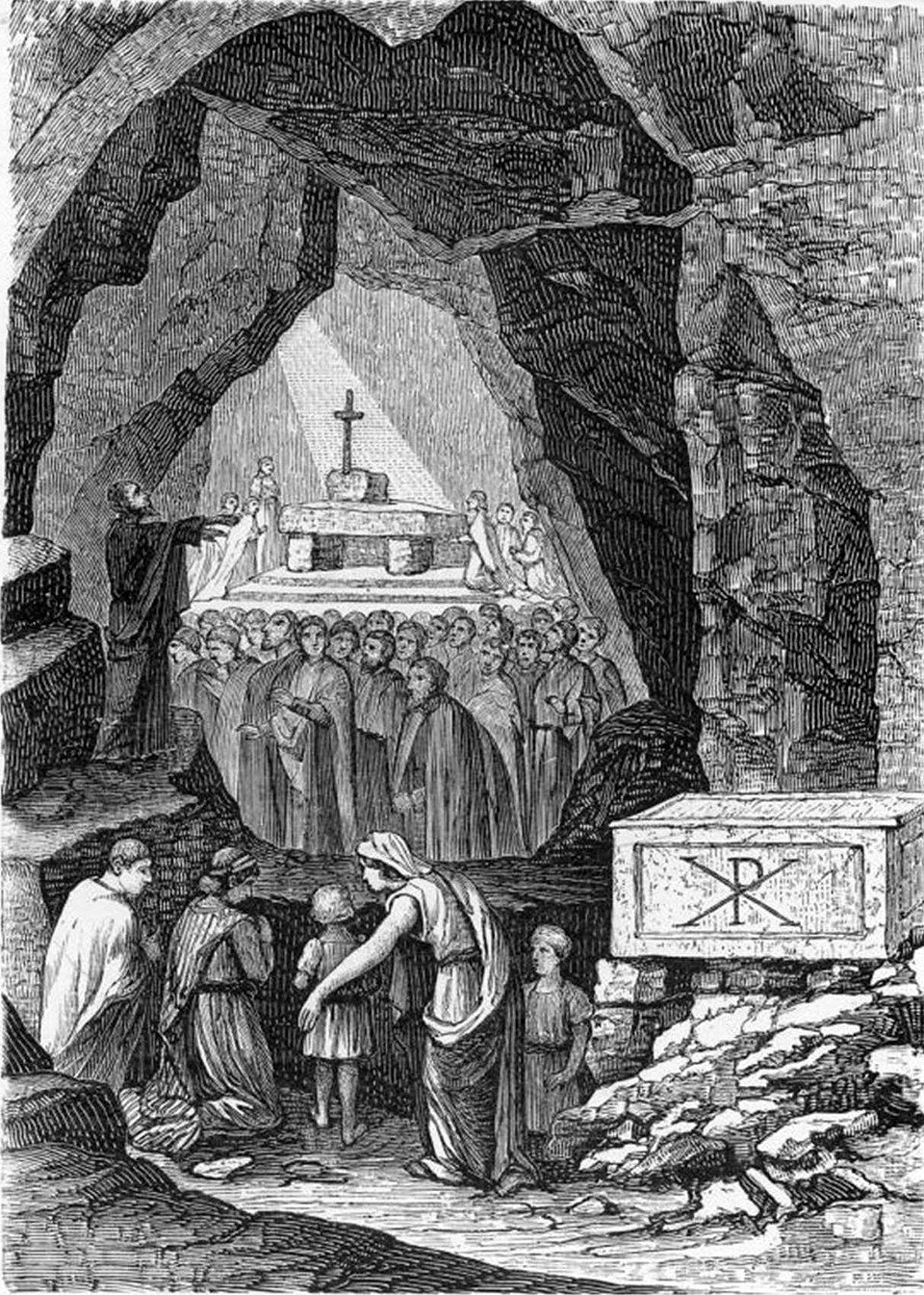 People gathered in a cave during a religious ceremony. A priest stands near an altar with a cross. Stone tomb with a Chi-Rho symbol.