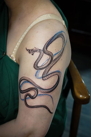 Best Blackwork Thai Naga tattoo with flow on the shoulder by Baan Khagee Tattoo Chiang Mai, Thailand