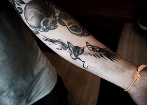 Best Blackwork abstract raven tattoo on forearm at Baan Khagee Tattoo Chiang Mai, Thailand