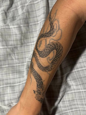 Healed Thai Naga tattoo on the forearm by Baan Khagee Tattoo Chiang Mai, Thailand