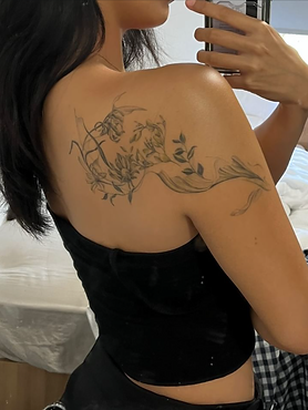 Healed flowing koifish with plants tattoo on the shoulder by Baan Khagee Tattoo Chiang Mai, Thailand