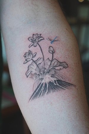 Best Fineline Thai lotus flowers with erupting volcano tattoo by Baan Khagee Tattoo Chiang Mai, Thailand
