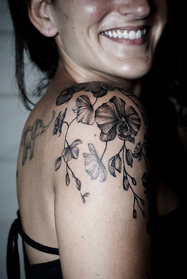 Best Blackwork orchid tattoo on shoulder at Baan Khagee Tattoo Chiang Mai, Thailand