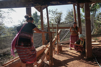 Local ladies enjoying the traditional rice mill at Mela local cooking experience in Mae Wang, Chiang Mai, Thailand