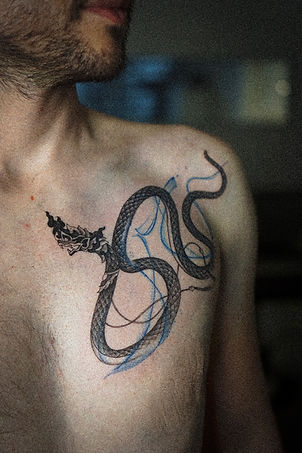 Best Blackwork Thai Naga tattoo with flow on the chest by Baan Khagee Tattoo Chiang Mai, Thailand