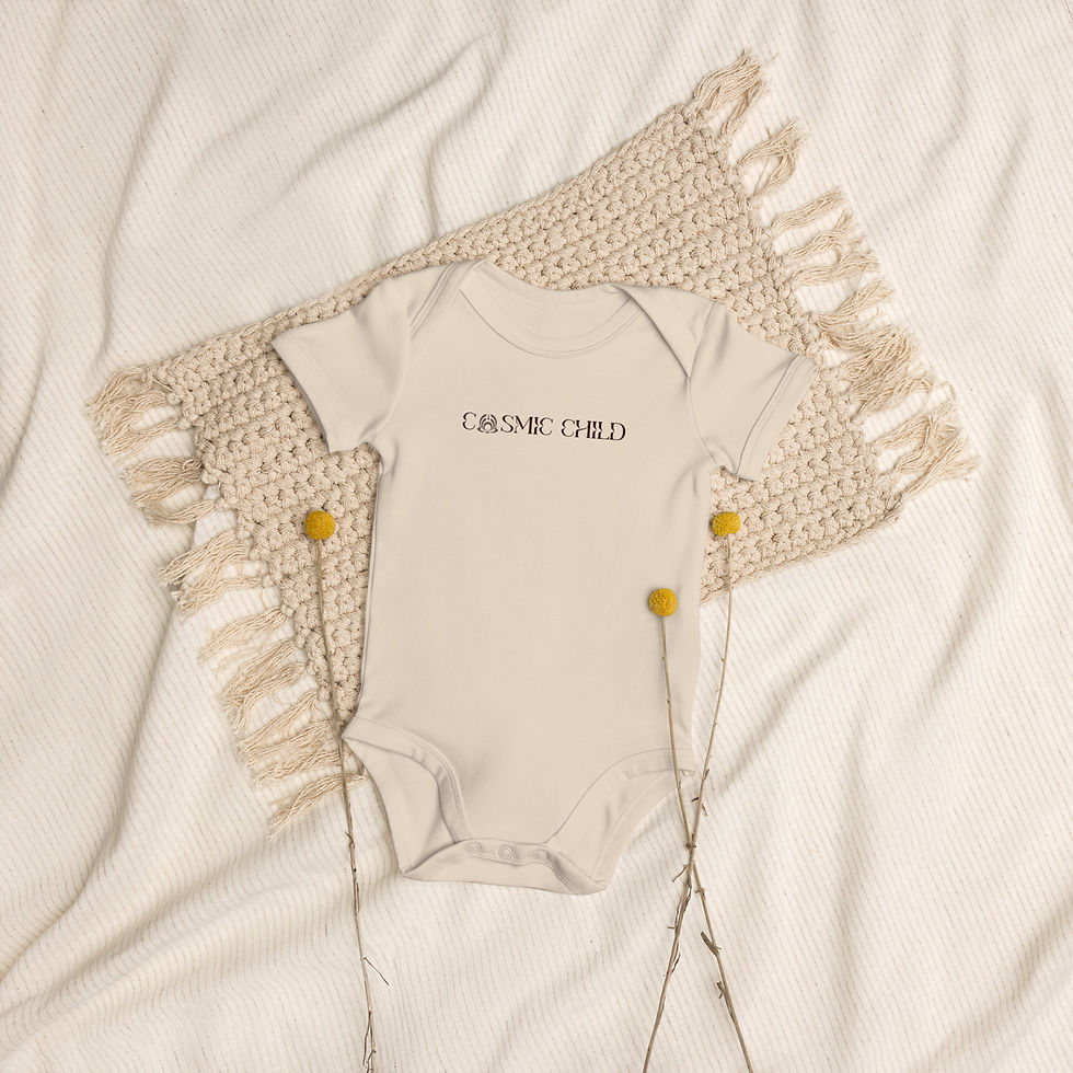 Thumbnail: Organic cotton baby body in nude beige with brown 'Cosmic Child' print on boho rug with yellow flowers