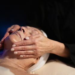 Hands performing a Recovery Facial