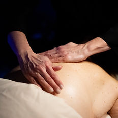 Hands massaging a person's back