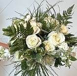 White and green lush bridal bouquet with whimsical flowers.