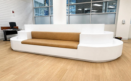 Commercial millwork built by Aurora Cabinets in Fort McMurray – curved white bench seating with upholstered cushions in a lobby