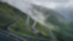 Mist and cloud rolls in over cars ascending Stelvio Pass in Italy's Alps