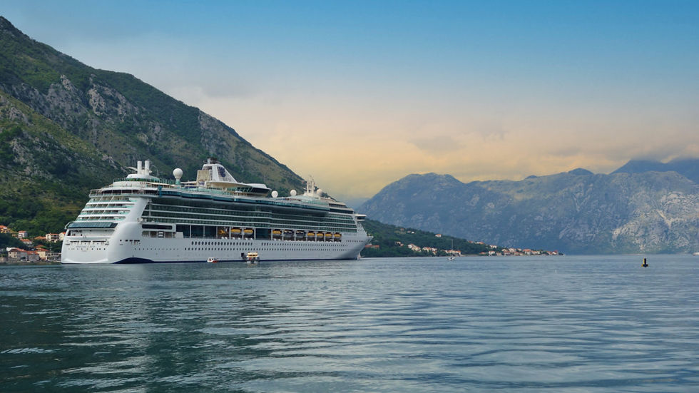 Royal Caribbean Serenade of the Seas in port and at tender under mountains and sky. Due a revitalization in 2022, Serenade of the Seas is a smaller ship perfect for more remote ports of call