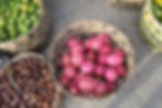 Dragon fruit and other exotic fruits in baskets on display in a Southeast Asian market