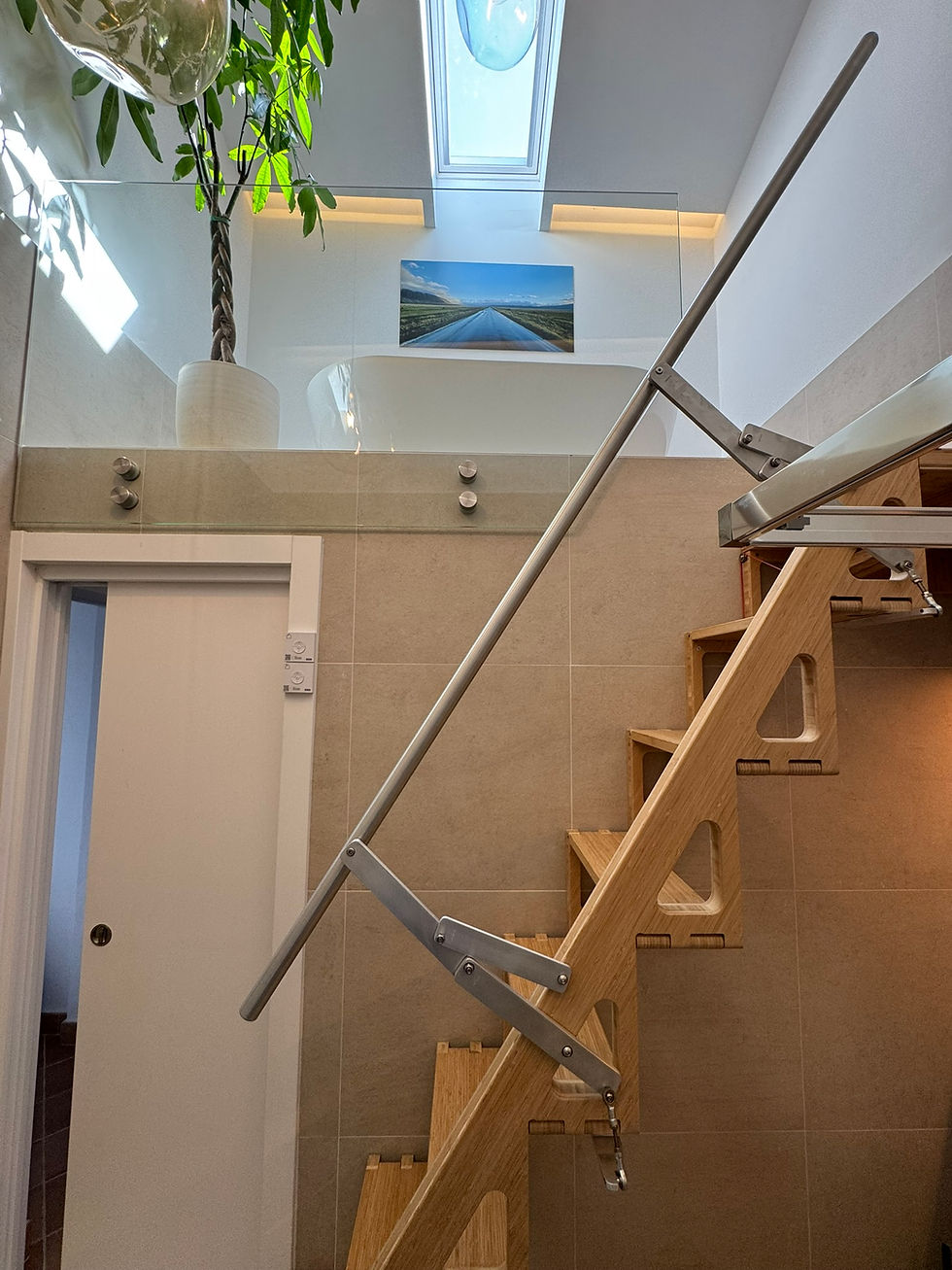 Eye-level view of a compact folding staircase installed in a small living room