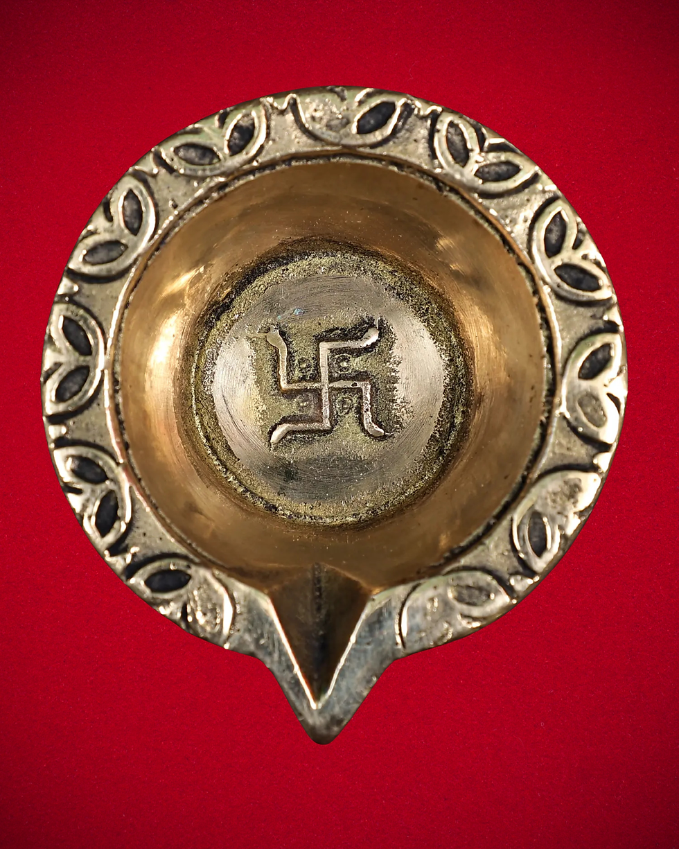 Small brass Swastik Vilakku with matching plate for pooja room rituals