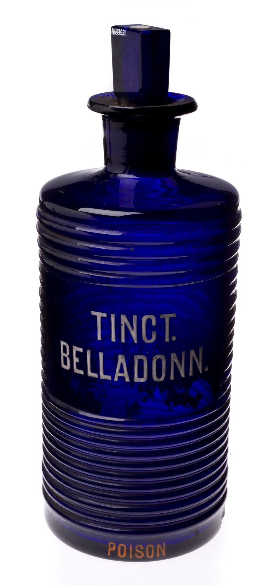 Ribbed cobalt blue bottle labelled “TINCT. BELLADONN.” and “POISON”