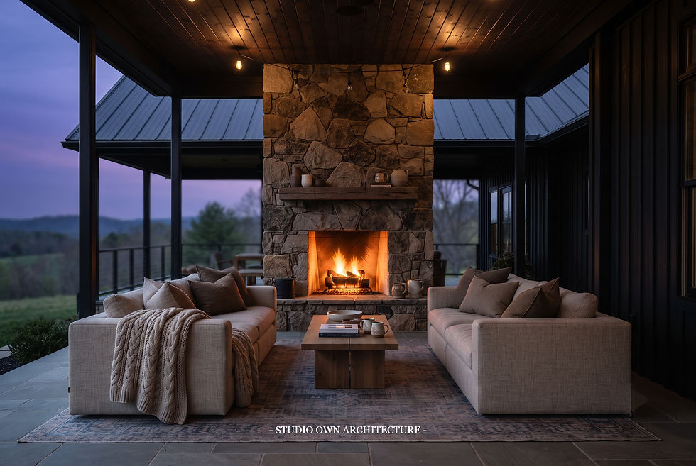 Cozy covered porch with stone fireplace, two beige sofas, and a glowing fire at dusk;