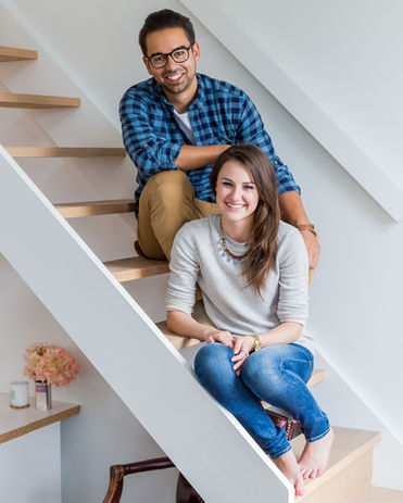 Happy couple on stairs in a bright, clean space