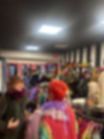 Customers shopping within the in-person Secondhand Circus retail location, where you can see the unique branding and unique vintage clothing options, as well as GG Gabennesch, the owner of Secondhand Circus connecting with one of her customers on opening day.
