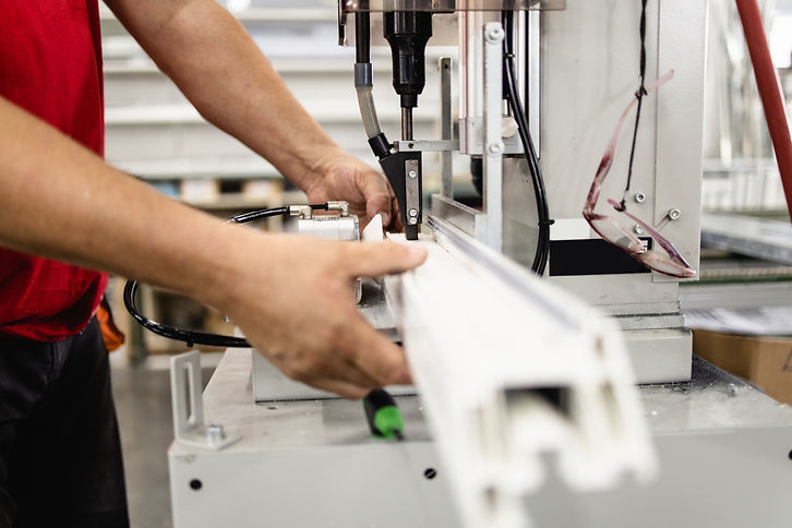 Manual worker assembling PVC doors and windows. Manufacturing jobs. Selective focus. Facto