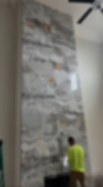 Large format marble tile fireplace installation