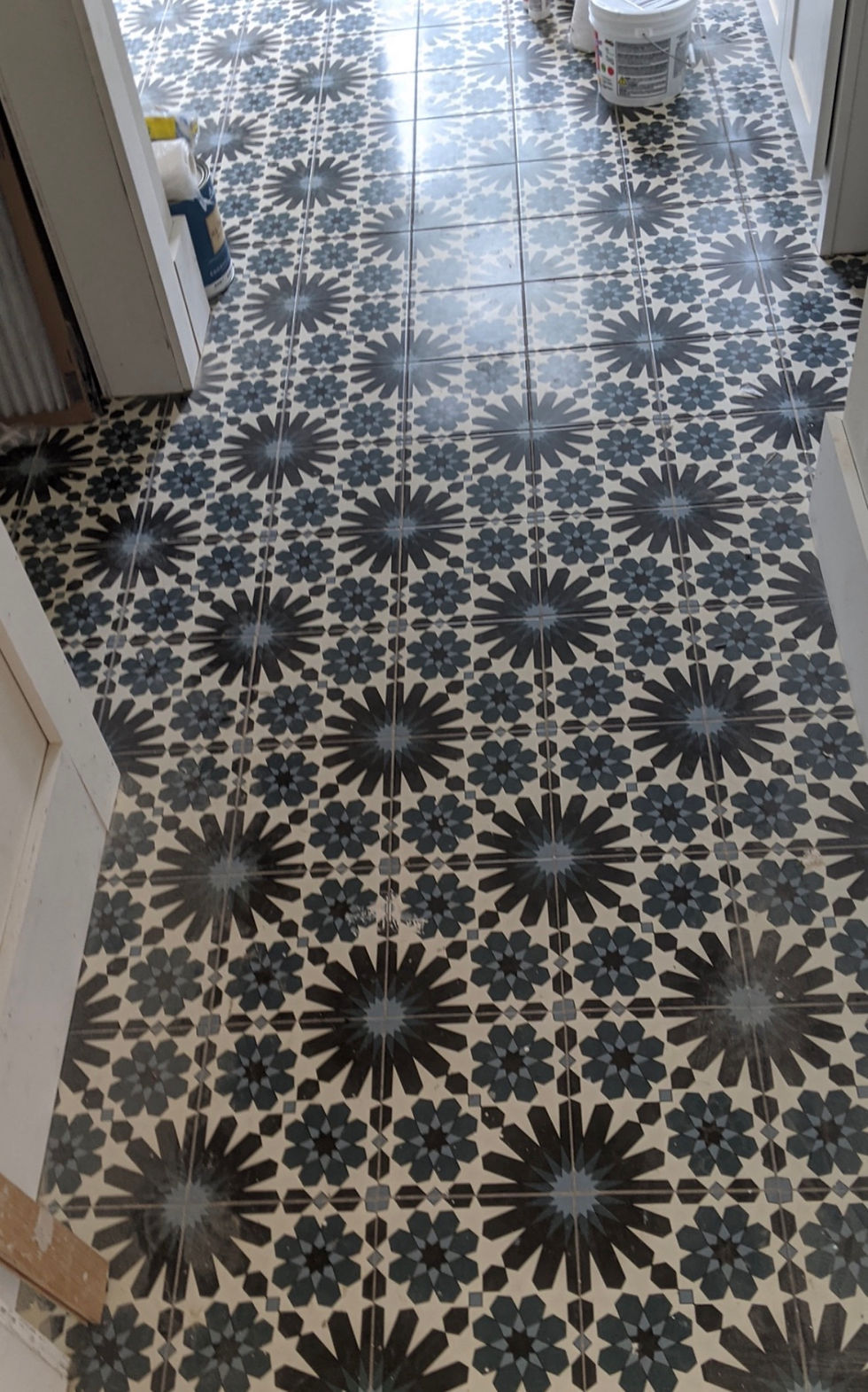 Residential tile installation of patterned floor tiles.