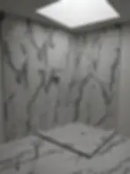 Modern marble shower with skylight and wall niche
