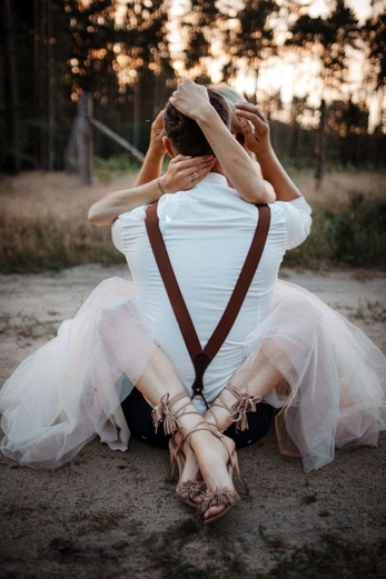 Couple embracing outdoors in romantic setting representing wedding inspiration and celebration moments.