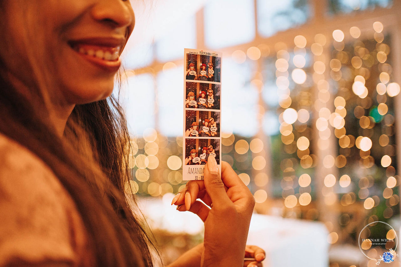 Smiling woman with her prints from a Photo Booth